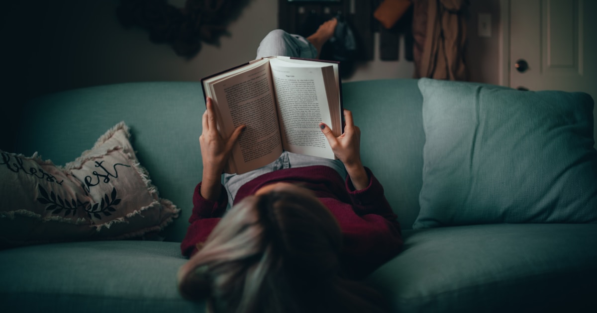 woman in red shirt reading book