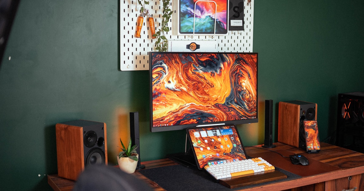 a desk with a computer and a monitor on it